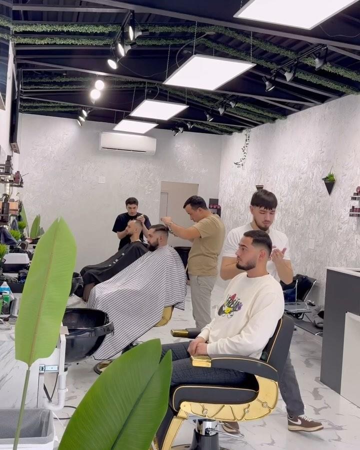 Barbers cutting hair inside Eleven Barbers, Midwood Brooklyn